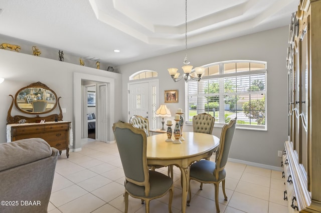 73 Foxhall Ln, Palm Coast, FL 32137 - dining room with a chandelier, a tray ceiling, light tile patterned floors, baseboards, and recessed lighting