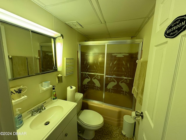 full bathroom with combined bath / shower with glass door, vanity, and toilet