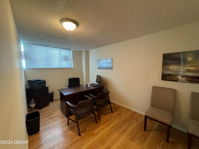 office with a textured ceiling and light hardwood / wood-style flooring