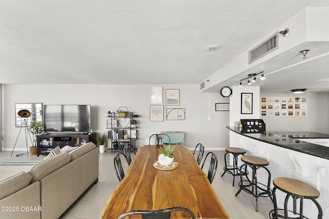 dining room featuring a textured ceiling