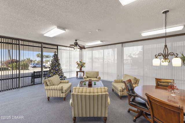 interior space with carpet flooring, ceiling fan with notable chandelier, and a textured ceiling