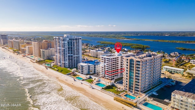 birds eye view of property featuring a water view and a view of the beach