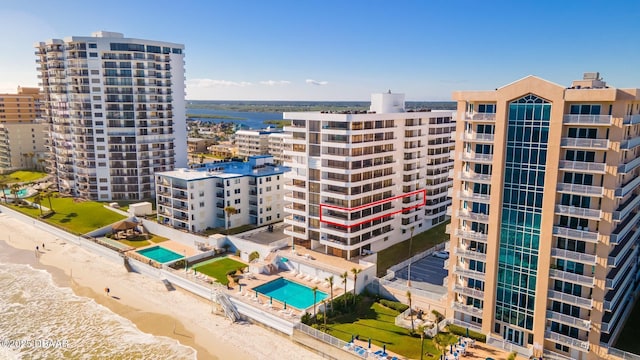 view of property featuring a water view and a beach view