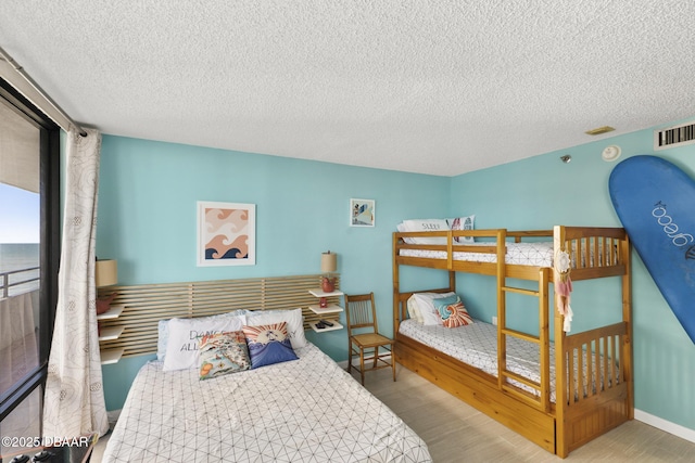 bedroom with light hardwood / wood-style floors and a textured ceiling