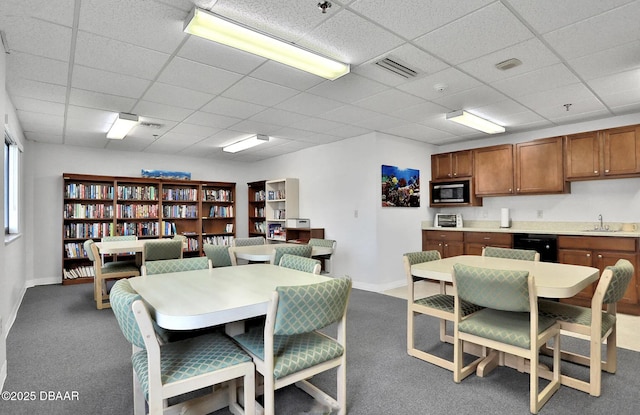 dining space featuring carpet floors and sink