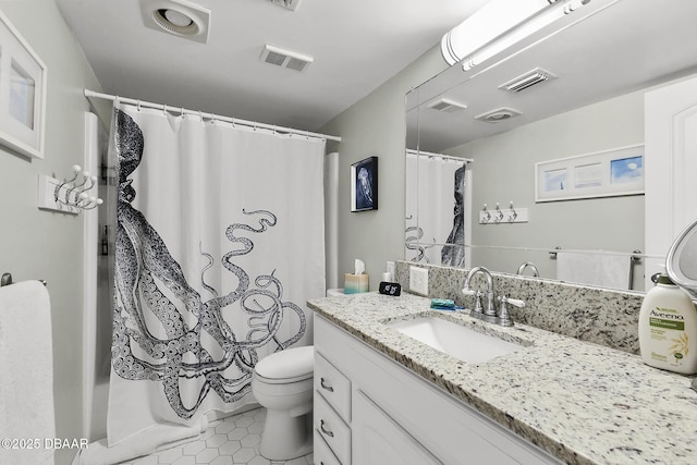 bathroom featuring tile patterned flooring, vanity, and toilet