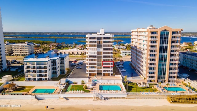 view of property featuring a water view and a beach view