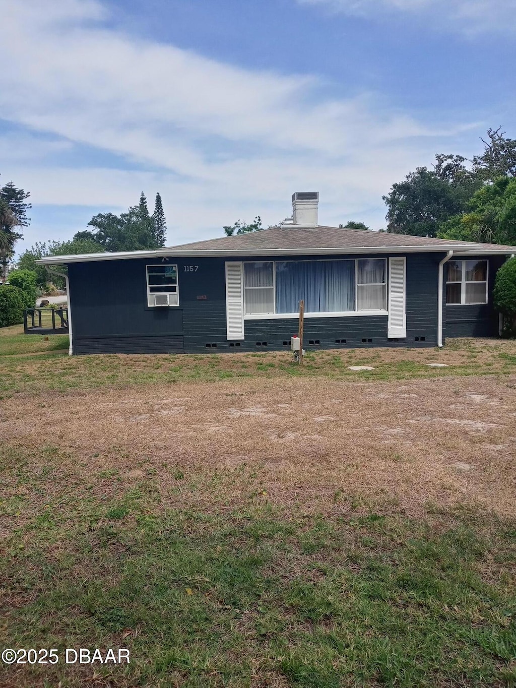 1157 John Anderson Dr, Ormond Beach, FL 32176 - view of front of house featuring a chimney, a front lawn, and crawl space