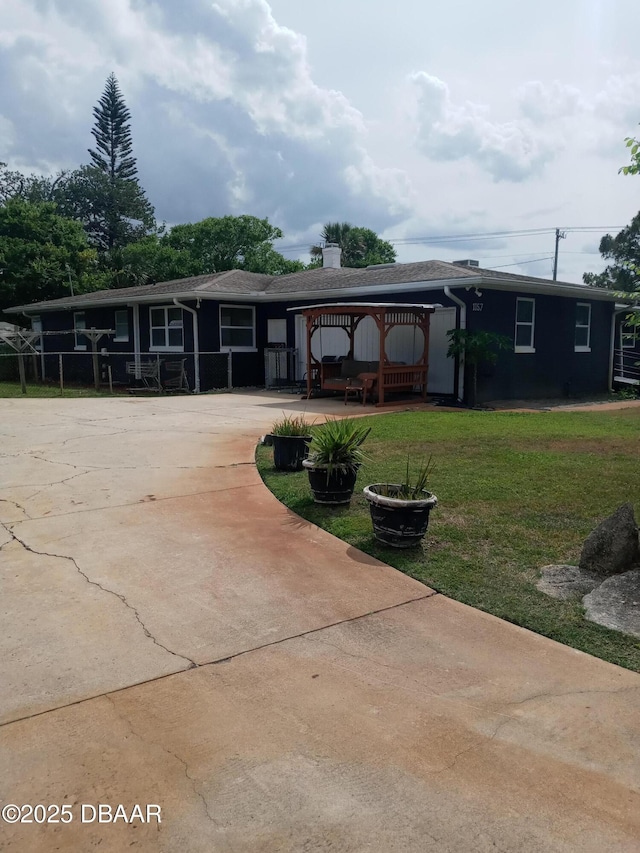 1157 John Anderson Dr, Ormond Beach, FL 32176 - exterior space with a lawn, a chimney, and driveway