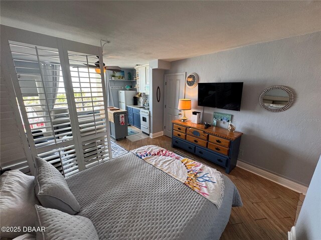 1233 S Atlantic Ave Unit 3070, Daytona Beach, FL 32118 - bedroom with wood finished floors, baseboards, and freestanding refrigerator