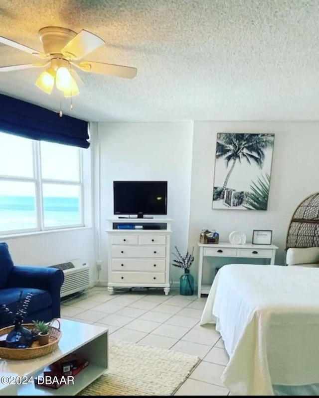 tiled bedroom with a textured ceiling and ceiling fan