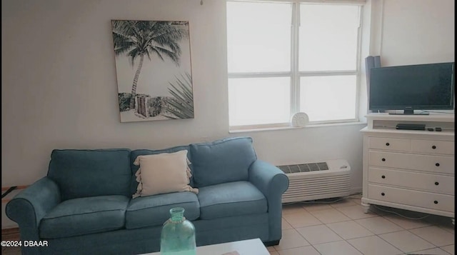 living room featuring light tile patterned flooring and a wall mounted AC