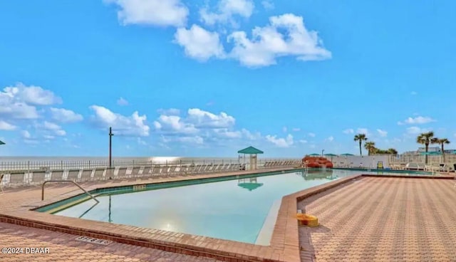 view of pool featuring a water view