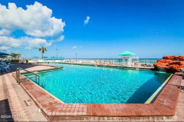 view of swimming pool featuring a water view