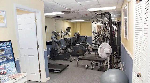 exercise room featuring a paneled ceiling