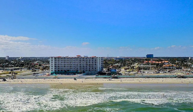 birds eye view of property with a beach view and a water view