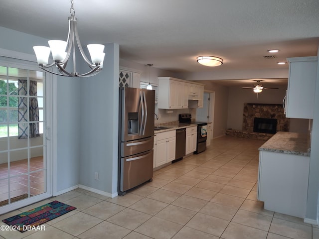 kitchen featuring stainless steel fridge with ice dispenser, dishwasher, range with electric stovetop, light tile patterned flooring, and white cabinetry