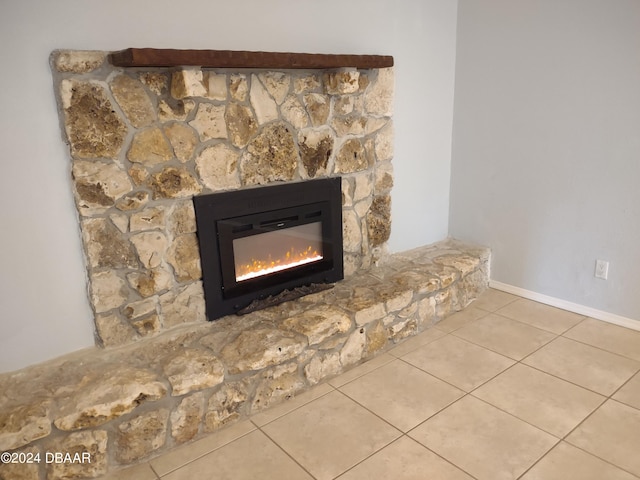 room details featuring baseboards and a fireplace