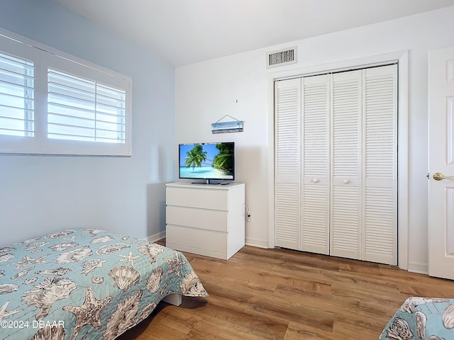 bedroom with a closet and light wood-type flooring