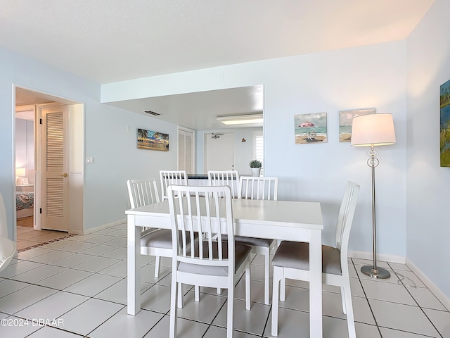 dining area featuring light tile patterned flooring