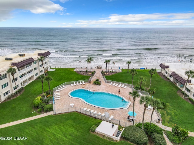 drone / aerial view with a water view and a beach view