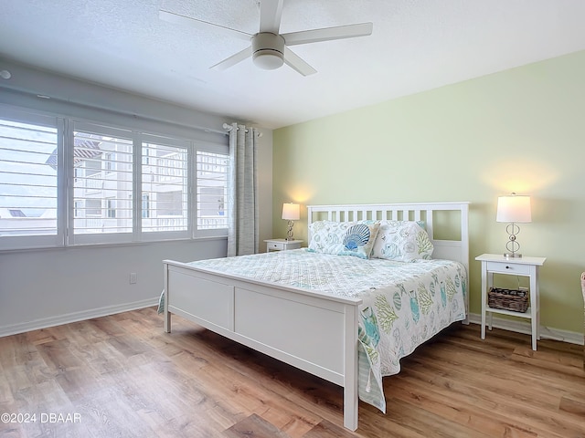 bedroom with hardwood / wood-style flooring and ceiling fan