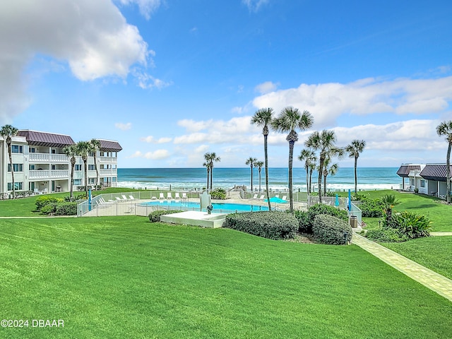 view of home's community featuring a water view, a swimming pool, and a yard