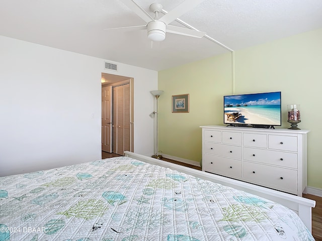 bedroom featuring ceiling fan, a closet, and wood-type flooring