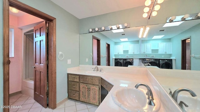 3128 John Anderson Dr, Ormond Beach, FL 32176 - bathroom with washer and dryer, tile patterned floors, and double vanity