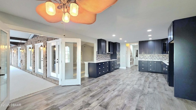 3128 John Anderson Dr, Ormond Beach, FL 32176 - kitchen featuring backsplash, light wood finished floors, light countertops, a ceiling fan, and recessed lighting