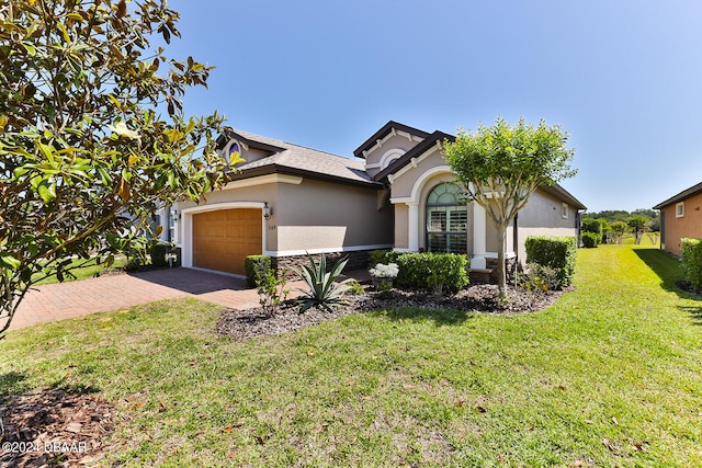 view of front of home with a garage and a front yard