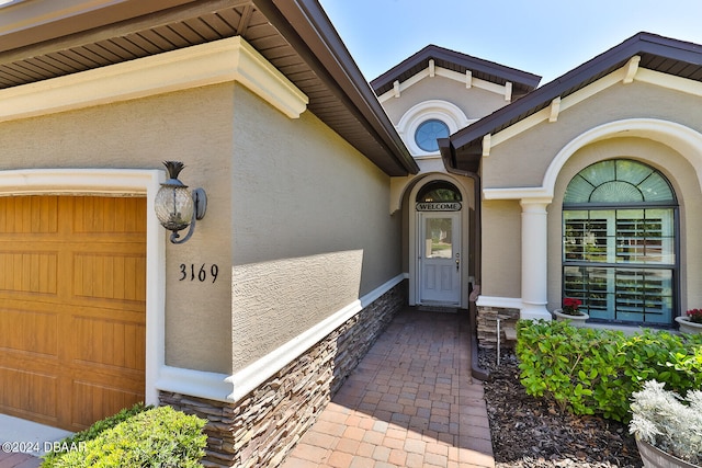 doorway to property with a garage