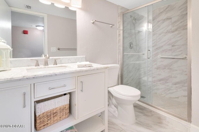 bathroom featuring a shower with door, vanity, and toilet