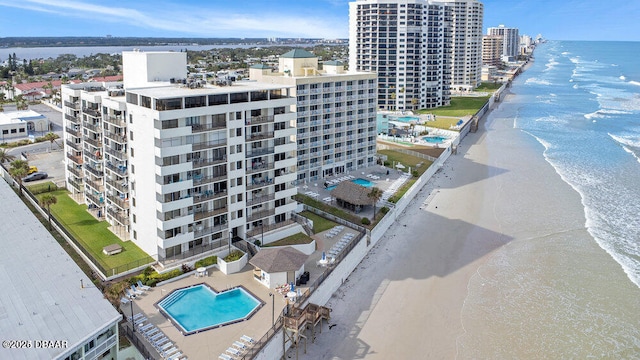 bird's eye view featuring a water view and a beach view