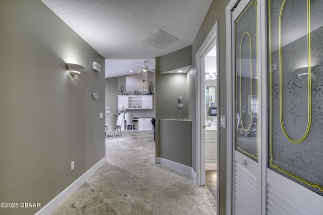7 Foxfords Chase, Ormond Beach, FL 32174 - corridor featuring a textured ceiling and baseboards