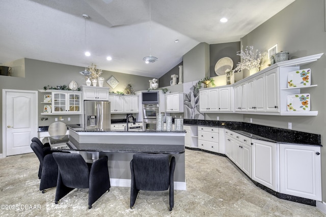 7 Foxfords Chase, Ormond Beach, FL 32174 - kitchen with open shelves, appliances with stainless steel finishes, white cabinetry, lofted ceiling, and a kitchen island with sink