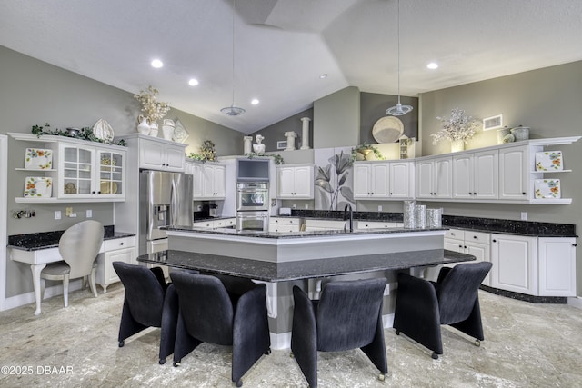 7 Foxfords Chase, Ormond Beach, FL 32174 - kitchen featuring open shelves, stainless steel appliances, white cabinetry, a spacious island, and a kitchen breakfast bar