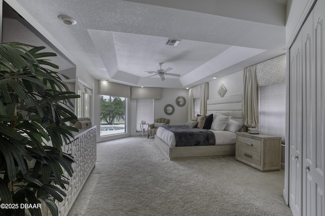 7 Foxfords Chase, Ormond Beach, FL 32174 - bedroom featuring light carpet, a tray ceiling, and a textured ceiling