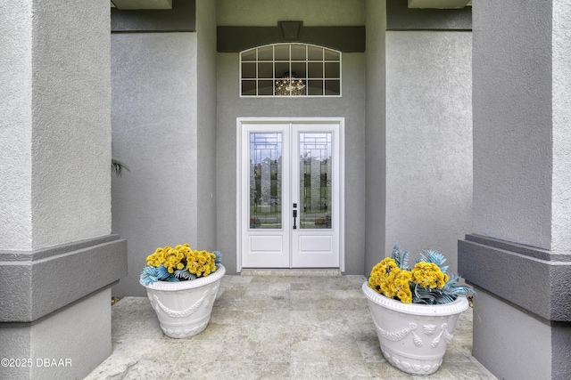 7 Foxfords Chase, Ormond Beach, FL 32174 - property entrance featuring french doors and stucco siding