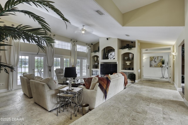 7 Foxfords Chase, Ormond Beach, FL 32174 - living room with vaulted ceiling, french doors, a ceiling fan, stone finish flooring, and a tiled fireplace