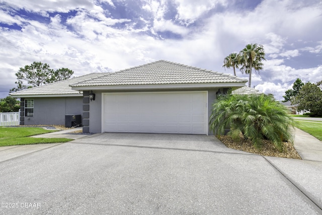 7 Foxfords Chase, Ormond Beach, FL 32174 - view of side of home featuring stucco siding, driveway, a garage, and a tiled roof