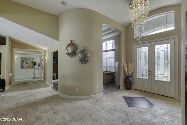 7 Foxfords Chase, Ormond Beach, FL 32174 - foyer with arched walkways, a chandelier, french doors, and high vaulted ceiling