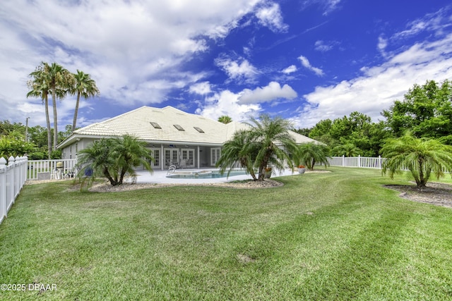 7 Foxfords Chase, Ormond Beach, FL 32174 - back of property featuring french doors, a fenced backyard, a tile roof, and a patio area