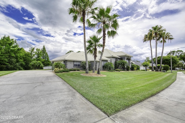 7 Foxfords Chase, Ormond Beach, FL 32174 - ranch-style home with a front lawn, stucco siding, and driveway