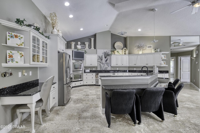 7 Foxfords Chase, Ormond Beach, FL 32174 - kitchen with appliances with stainless steel finishes, open shelves, ceiling fan, white cabinets, and vaulted ceiling