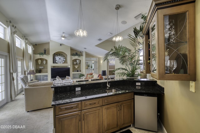 7 Foxfords Chase, Ormond Beach, FL 32174 - kitchen featuring dishwasher, open floor plan, dark stone counters, and lofted ceiling