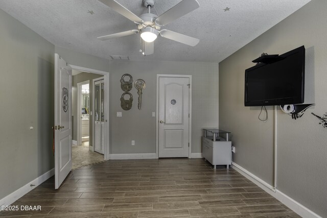 7 Foxfords Chase, Ormond Beach, FL 32174 - unfurnished living room featuring wood finished floors, ceiling fan, and a textured ceiling