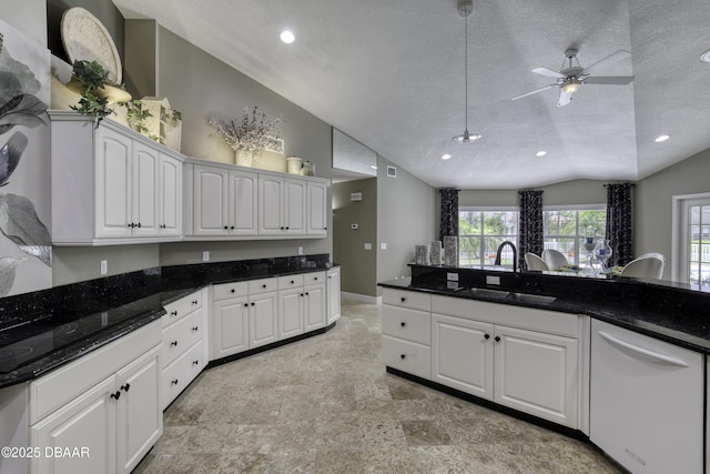 7 Foxfords Chase, Ormond Beach, FL 32174 - kitchen with white dishwasher, lofted ceiling, a textured ceiling, ceiling fan, and white cabinetry