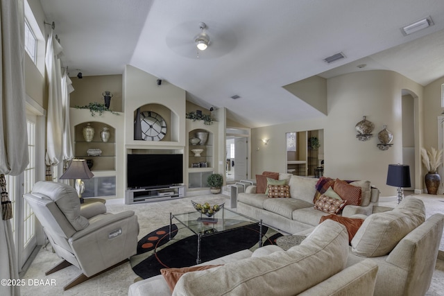 7 Foxfords Chase, Ormond Beach, FL 32174 - living room with vaulted ceiling, ceiling fan, built in shelves, arched walkways, and light carpet