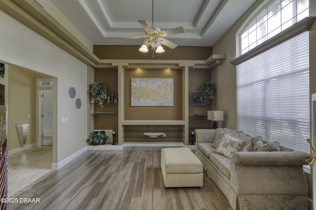 7 Foxfords Chase, Ormond Beach, FL 32174 - living area featuring a tray ceiling, ceiling fan, and wood finished floors